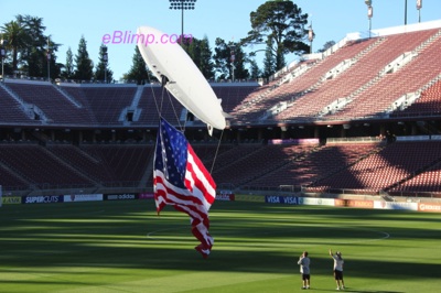 RC blimp flying remote control flag at soccer game
